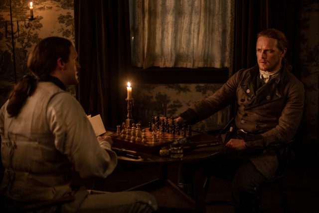 A chess match. Sam Heughan as Jamie Fraser